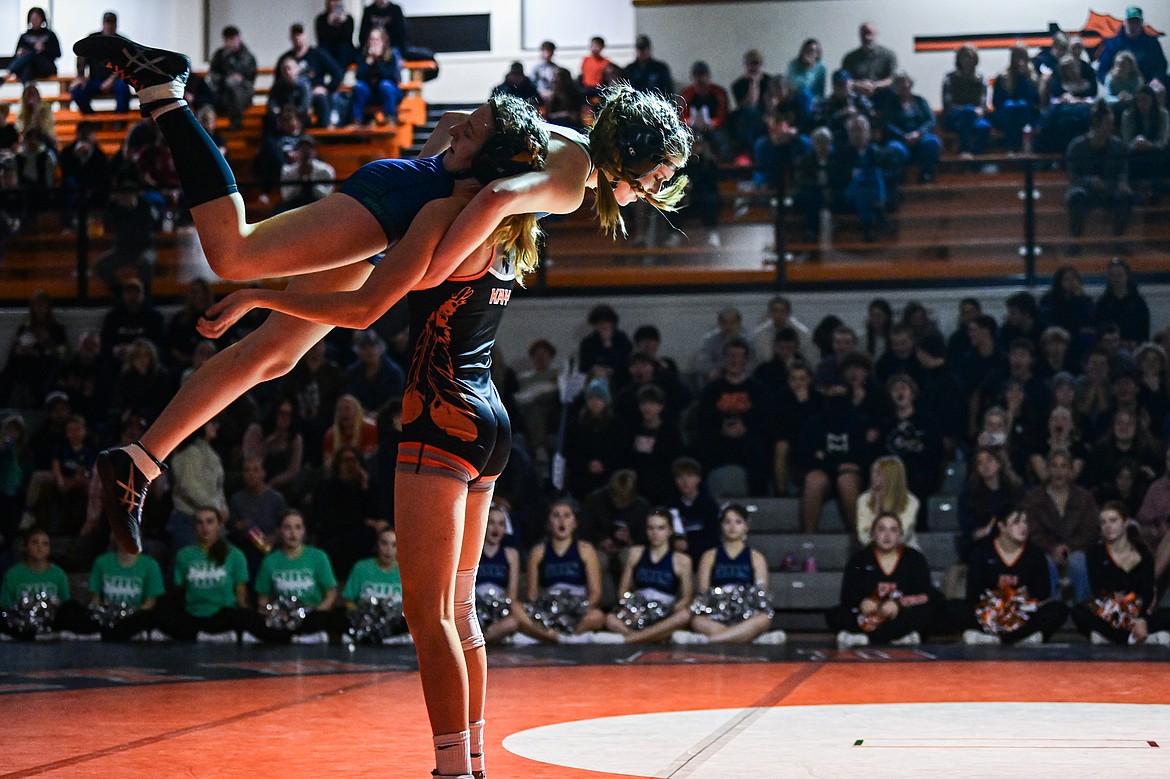 Flathead's Julia Kay scoops up Glacier's Ella Labrum at 125 pounds at Flathead High School on Thursday, Jan. 9. (Casey Kreider/Daily Inter Lake)