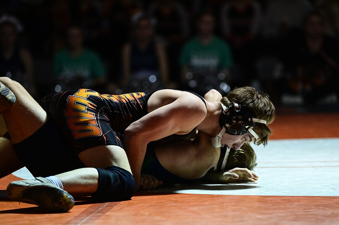 Flathead's Daniel Evert works toward a pin of Glacier's Dillon Sams at 138 pounds at Flathead High School on Thursday, Jan. 9. (Casey Kreider/Daily Inter Lake)