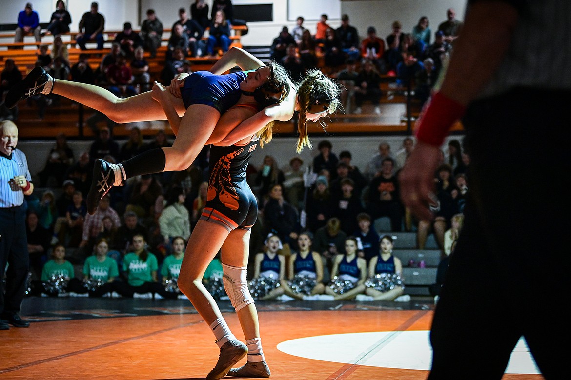 Flathead's Julia Kay scoops up Glacier's Ella Labrum at 125 pounds at Flathead High School on Thursday, Jan. 9. (Casey Kreider/Daily Inter Lake)