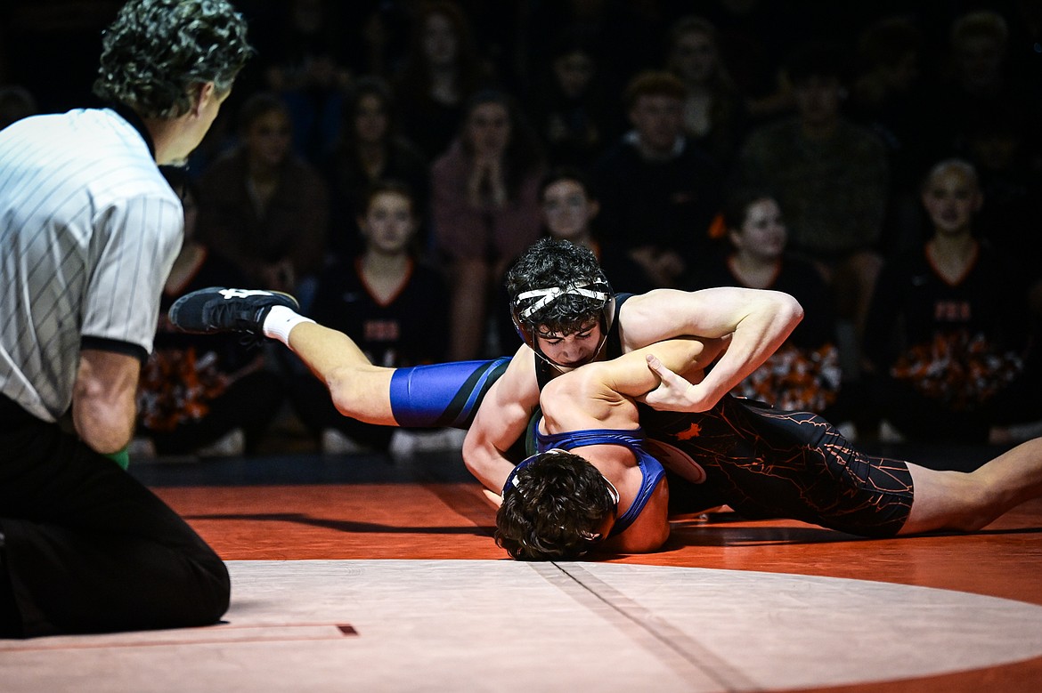 Flathead's Hunter Arriaga works toward a pin of Glacier's Wyatt Jensen at 132 pounds at Flathead High School on Thursday, Jan. 9. (Casey Kreider/Daily Inter Lake)