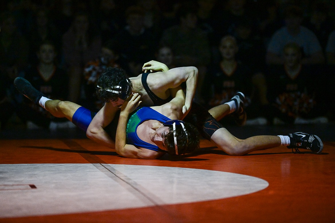 Flathead's Hunter Arriaga works toward a pin of Glacier's Wyatt Jensen at 132 pounds at Flathead High School on Thursday, Jan. 9. (Casey Kreider/Daily Inter Lake)