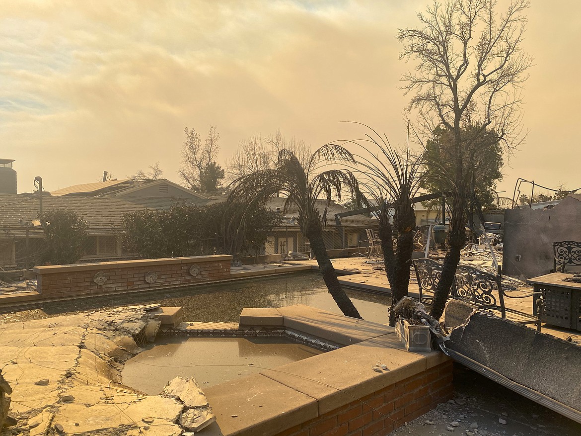 The Budge family's pool was filled with ash and debris after their home burnt down in the Eaton Canyon fire near Pasadena, Calif. Tuesday night.