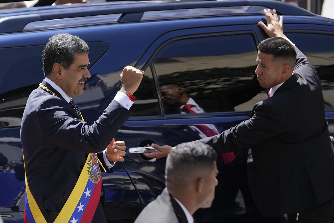 Venezuela's President Nicolas Maduro gestures to government supporters before entering a vehicle after his inauguration for a third term in Caracas, Venezuela, Friday, Jan. 10, 2025. (AP Photo/Matias Delacroix)