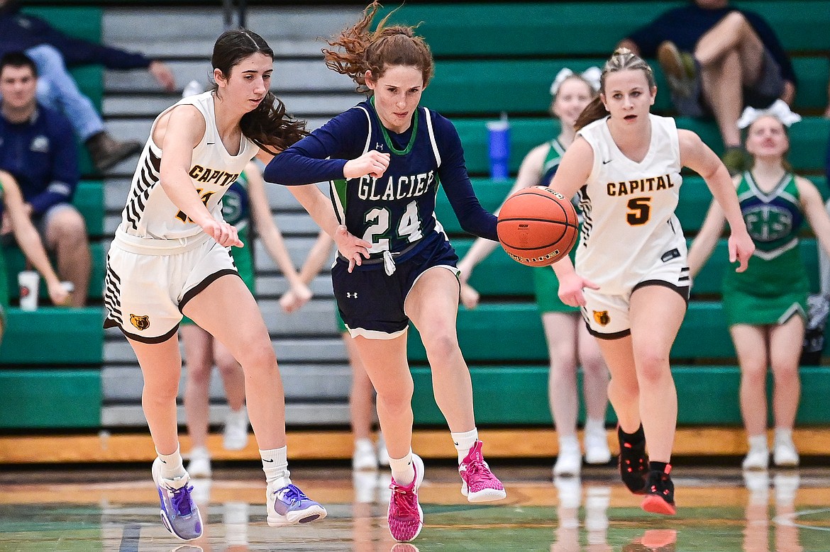 Glacier's Cassidy Daniels (24) scoops up a loose ball for a steal in the second quarter against Helena Capital at Glacier High School on Saturday, Jan. 11. (Casey Kreider/Daily Inter Lake)