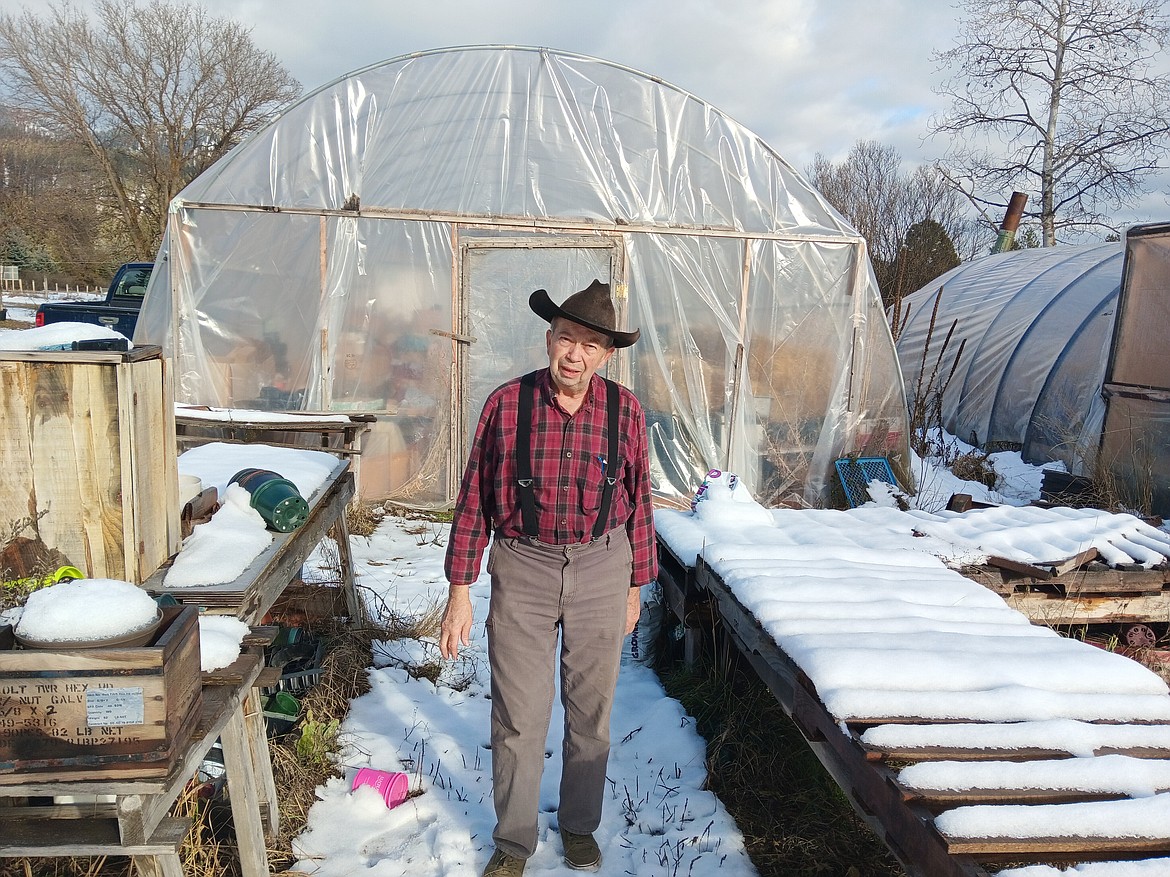 Milton Pearce stands where two huge Ponderosa pines trees fell onto his greenhouse almost three years ago. One was on each side, sending Pearce to the hospital from the branches whacking the daylights out of him. The neighbors helped with the salvage effort and The Potting Shed has had exceptional growth since then. (Monte Turner/Mineral Independent)