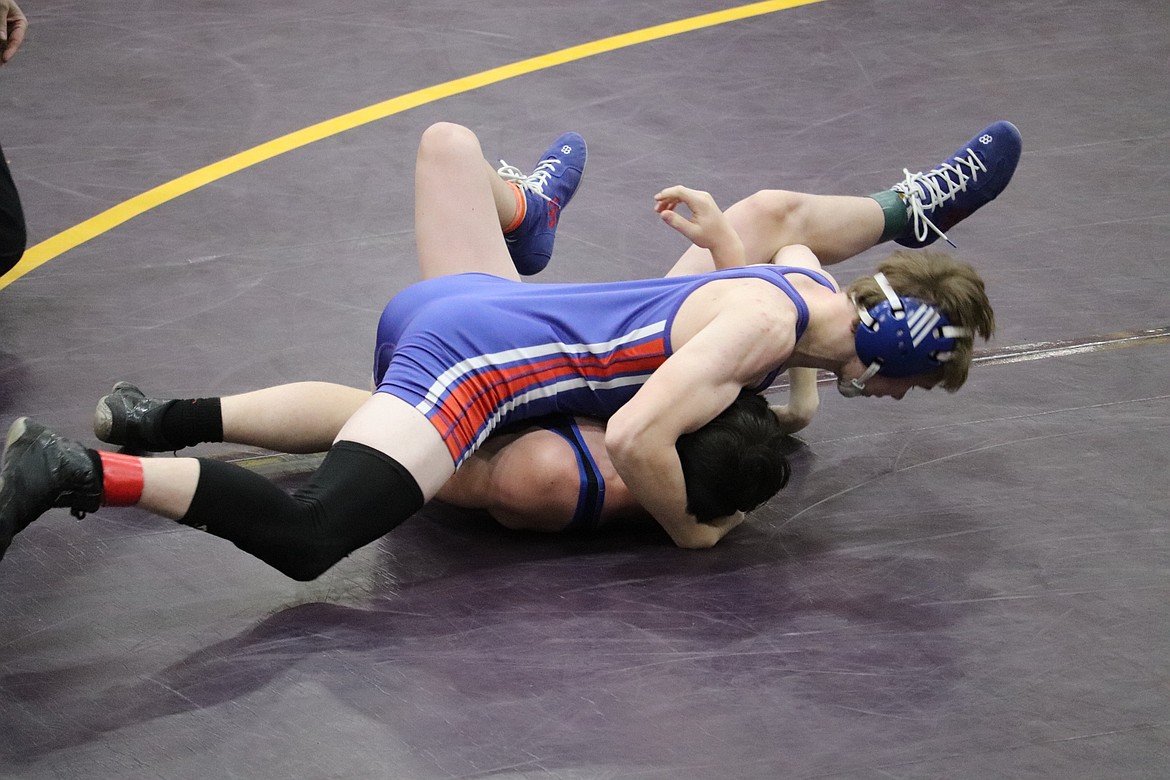 Dylon Arbogast of Superior (blue) goes for a pin during a 126-pounder match at the Cut Bank Booster Invitational this past weekend.  (Photo by Kami Milender)