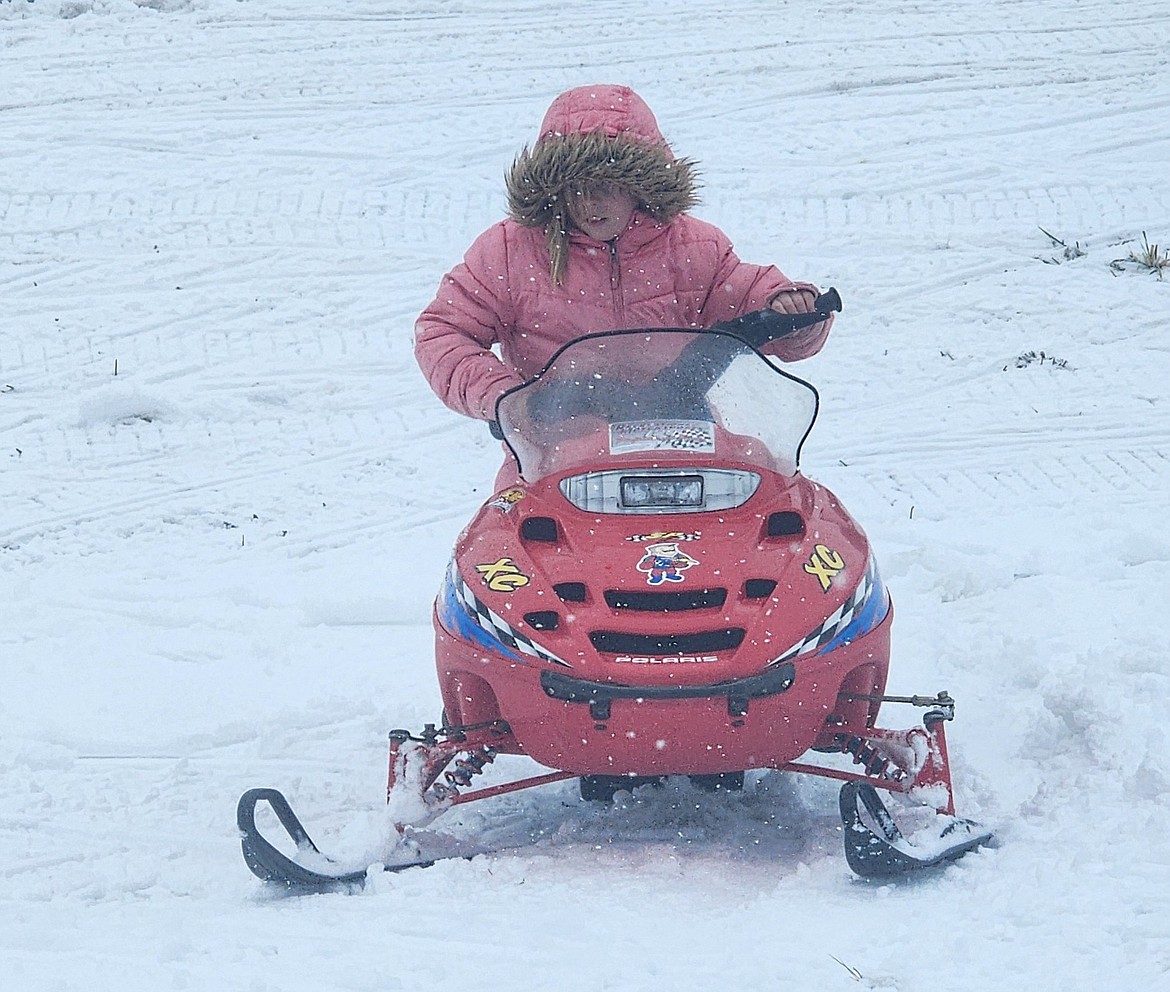 Charlotte Fulwiler careened around the field next to the Miracle of America Museum during Saturday's Winter Fest. (Berl Tiskus/Leader)