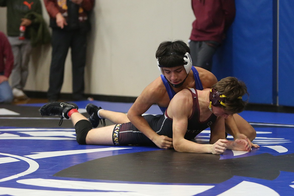 Warden senior Junior Santiago, top, wrestles against Moses Lake senior Jesse Humpherys at Saturday’s tournament in Warden. Santiago took third in the 144-pound class, while Humpherys tied for sixth.