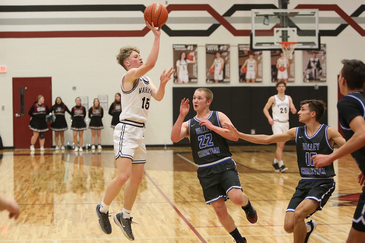 Almira/Coulee-Hartline eighth-grader Nolan Grindy (15) launches a three-pointer during Tuesday’s game against Valley Christian.