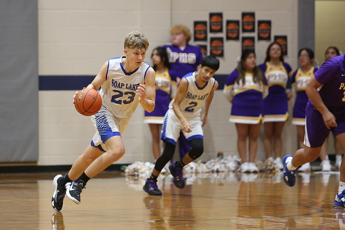 Soap Lake senior Ruvim Goloborodko, left, brings the ball up the floor during a game in the 2023-24 season. Goloborodko, who returned from an injury earlier this month, is one of three returners of last year’s team.