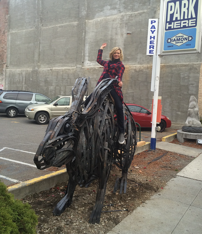 Metal artist Tyree Riggs is seen with her "Harvey" creation when it was installed next to the Art Spirit Gallery in November 2015. Harvey has been purchased by a couple in Phoenix and is expected to be installed at its new home next week.