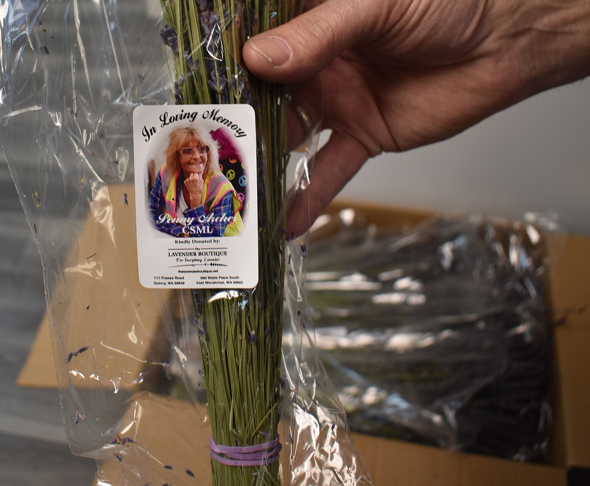 Each bundle of aromatic lavender donated by Lavender Ranch is labeled with a photo in memory of Moses Lake Food Bank Director Peny Archer, who passed away earlier this month.