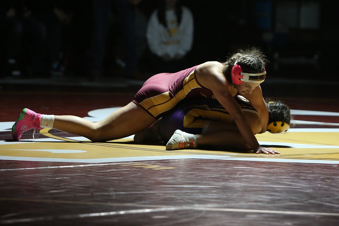 Moses Lake junior Hayden Morris, top, won her match in a 3-2 decision in the 120-pound class.