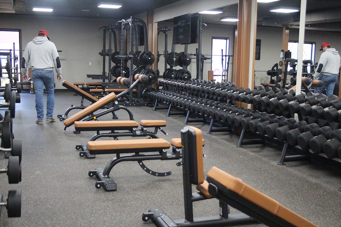 A customer inspects the free weight section of the new Pillar Fitness in Othello during Friday’s open house.