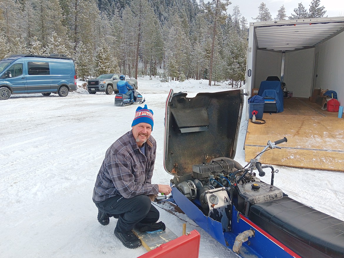 David Brummer from Post Falls Idaho has 70 vintage snowmobiles but only brought 5 last weekend for the 8th Winterfest, but it was the first time it was held in Haugan, Montana. The Polaris he is working on is a 3-cylinder 440 cubic inch that is one of his favorites. He entered the timed event but was primarily there for the vintage snowmobile ride to the Montana Bar in Saltese for lunch on Sunday. (Monte Turner/Mineral Independent)