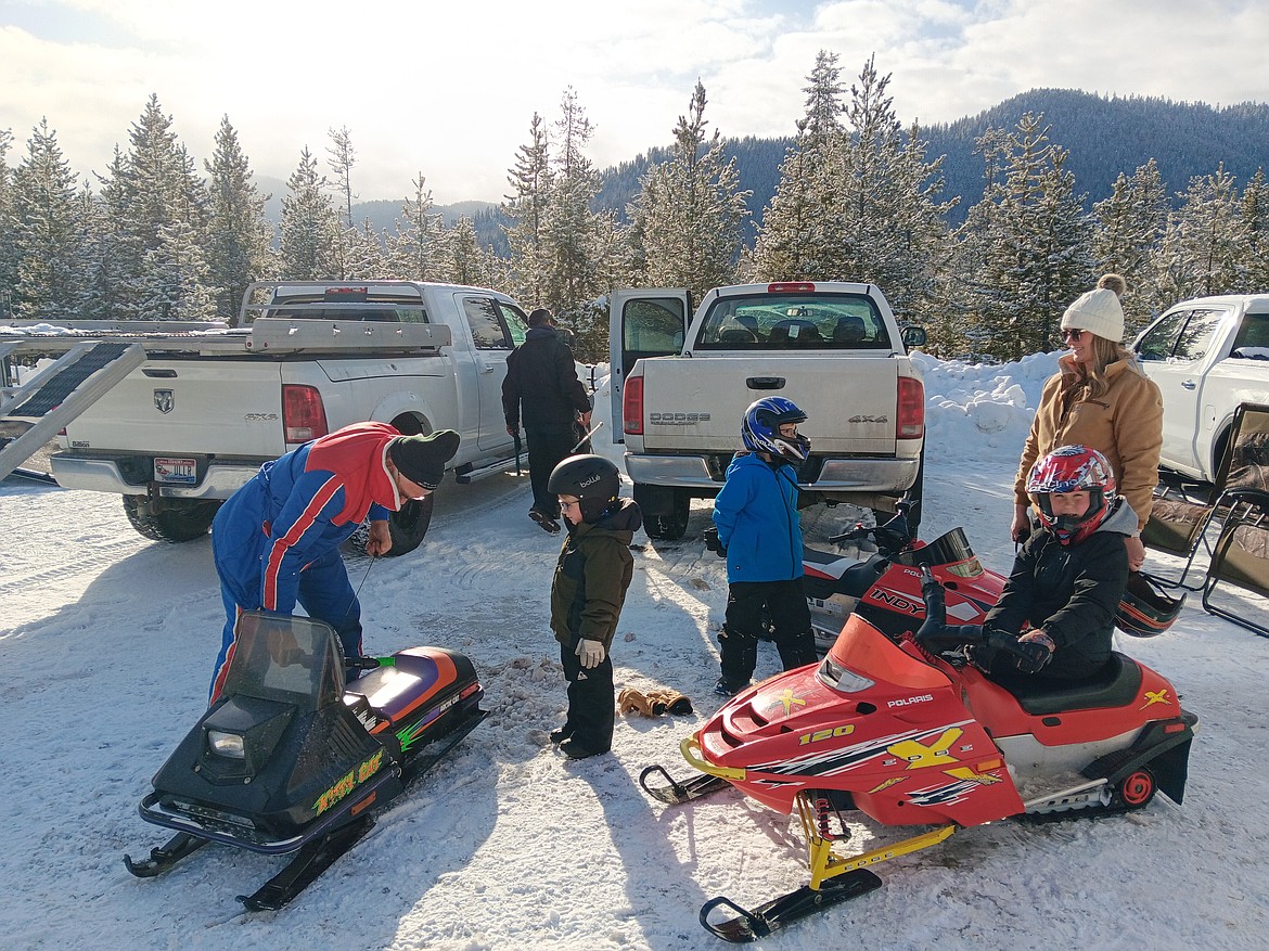 A couple from Potomac, Montana brought their 3 boys and grampa, who is the real snowmobile enthusiast, last Saturday for the vintage snowmobile show and to watch others ride the timed course. The day had family rides, campfires, sledding and food with blue skies and low 20’s for a perfect setting. (Monte Turner/Mineral Independent)