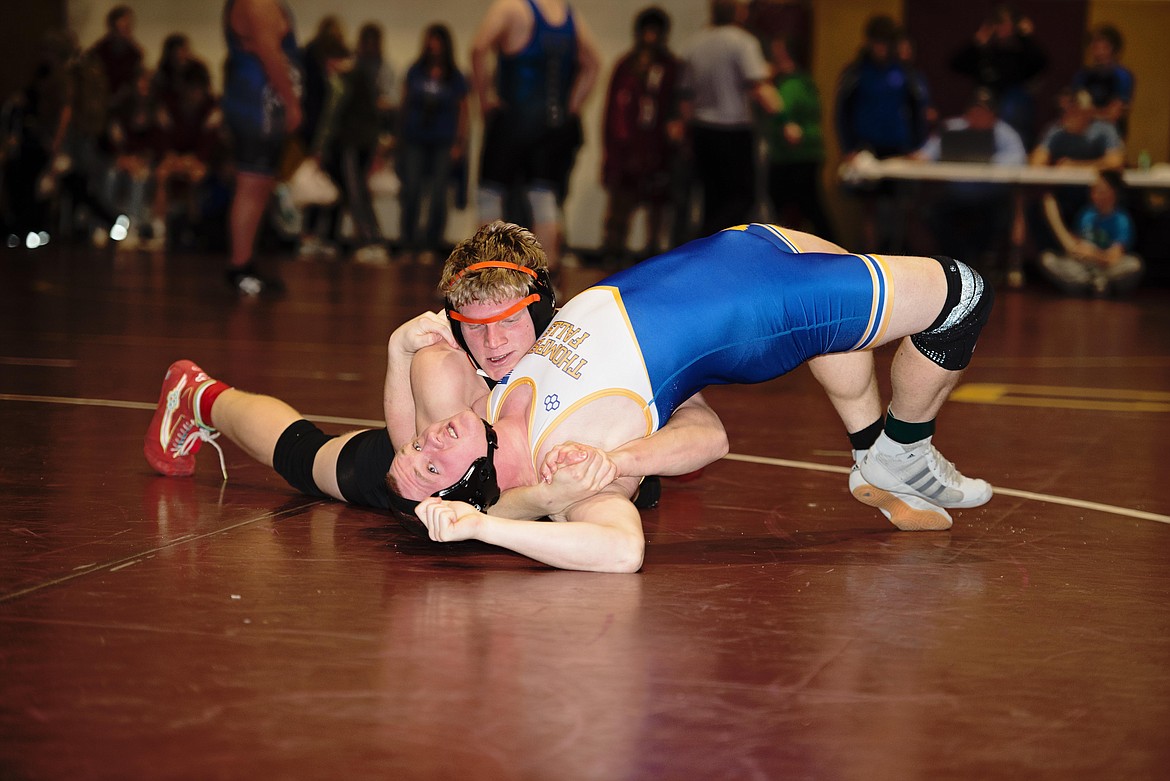 Plains-Hot Springs senior 190-pounder David Chapman (black uniform) nears a pin of an opponent during this past weekend's Choteau Classic wrestling event.  (Photo by Teresa Waterbury)