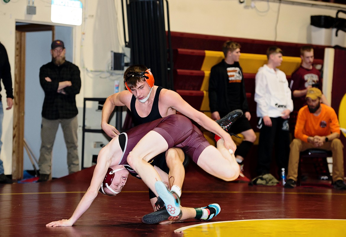 Plains wrestler Gavin Schrenk (black uniform) works to control an opponent during this past weekend's Choteau Classic wrestling event.  Schrenk placed third in the 132-pound weight category for the Plains-Hot Springs co-op team.  (Photo by Teresa Waterbury)