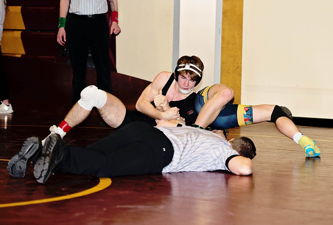 Plains-Hot Springs 157-pound senior John Waterbury goes for the pin during this past weekend's Choteau Classic wrestling tournament.  Waterbury won the 157-pound individual title. (Photo by Teresa Waterbury)