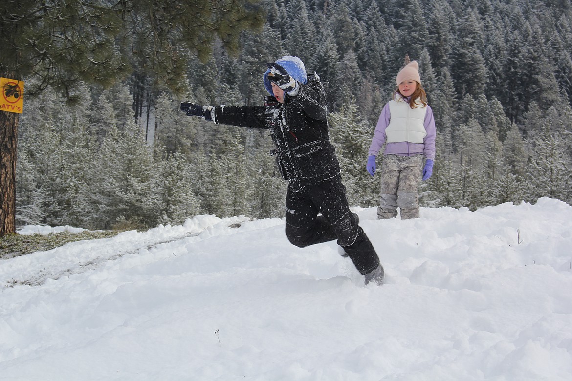 When kids weren’t roasting hotdogs and marshmallows over the small campfires or riding their own junior-sided snowmobiles, the reverted back to kid stuff of playing in the ample snow piles in Haugan at 2025 Winterfest. (Monte Turner/Mineral Independent)