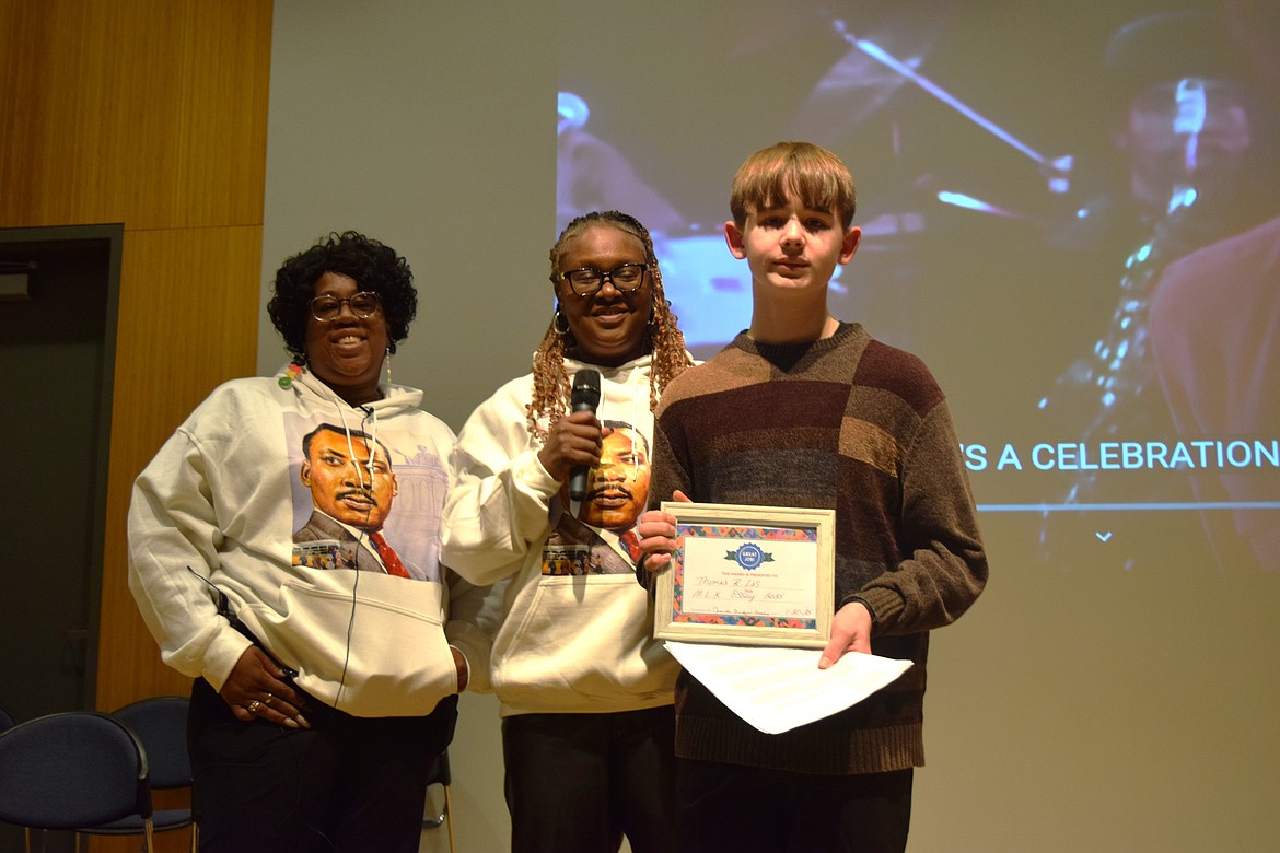 Thomas Los, right, earned third place for the Martin Luther King Jr. Essay Contest. Moses Lake Martin Luther King Jr. Committee Vice President LaDonna Richie, left, and Moses Lake Martin Luther King Jr. Committee President Miranda Bridges-Lindsey, middle, presented the award to Serrano.