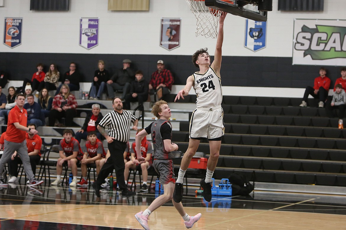 Royal sophomore Grant Wardenaar (24) lays the ball in for a basket against Riverside on Jan. 3. Wardenaar scored 22 points against Zillah on Friday and led the Knights with 11 points in Saturday’s win over Chelan.