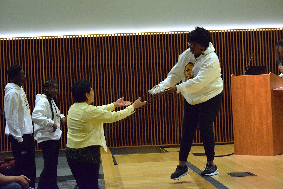 MLK Committee Vice President LaDonna Richie hands an award to Linda Jones, the wife of their former president, Charlie Jones. The Moses Lake Martin Luther King, Jr. Committee thanked Linda for her patience as Charlie worked with the group. Charlie passed away in July of 2024, making this the first MLK celebration since his passing.