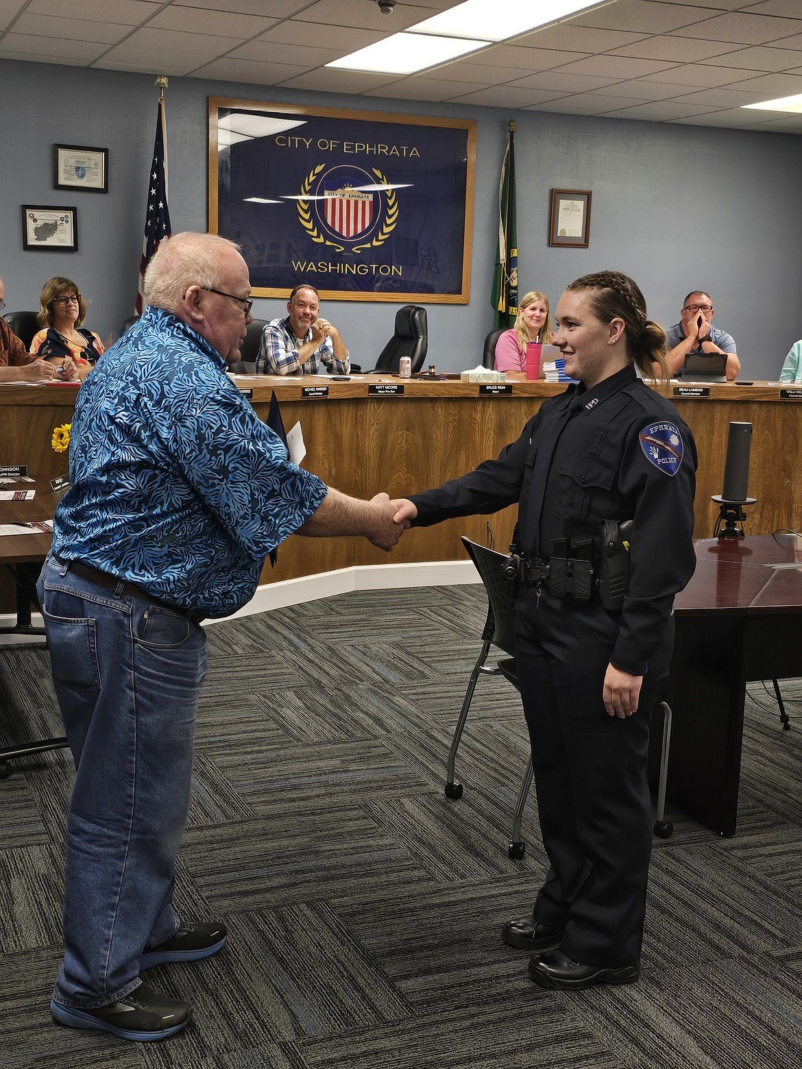 Ephrata Police Department’s newest officer, Rebecca Amos was sworn in during an August city council meeting. Above, Ephrata Mayor Bruce Reim shakes Amos’s hand after swearing her in.