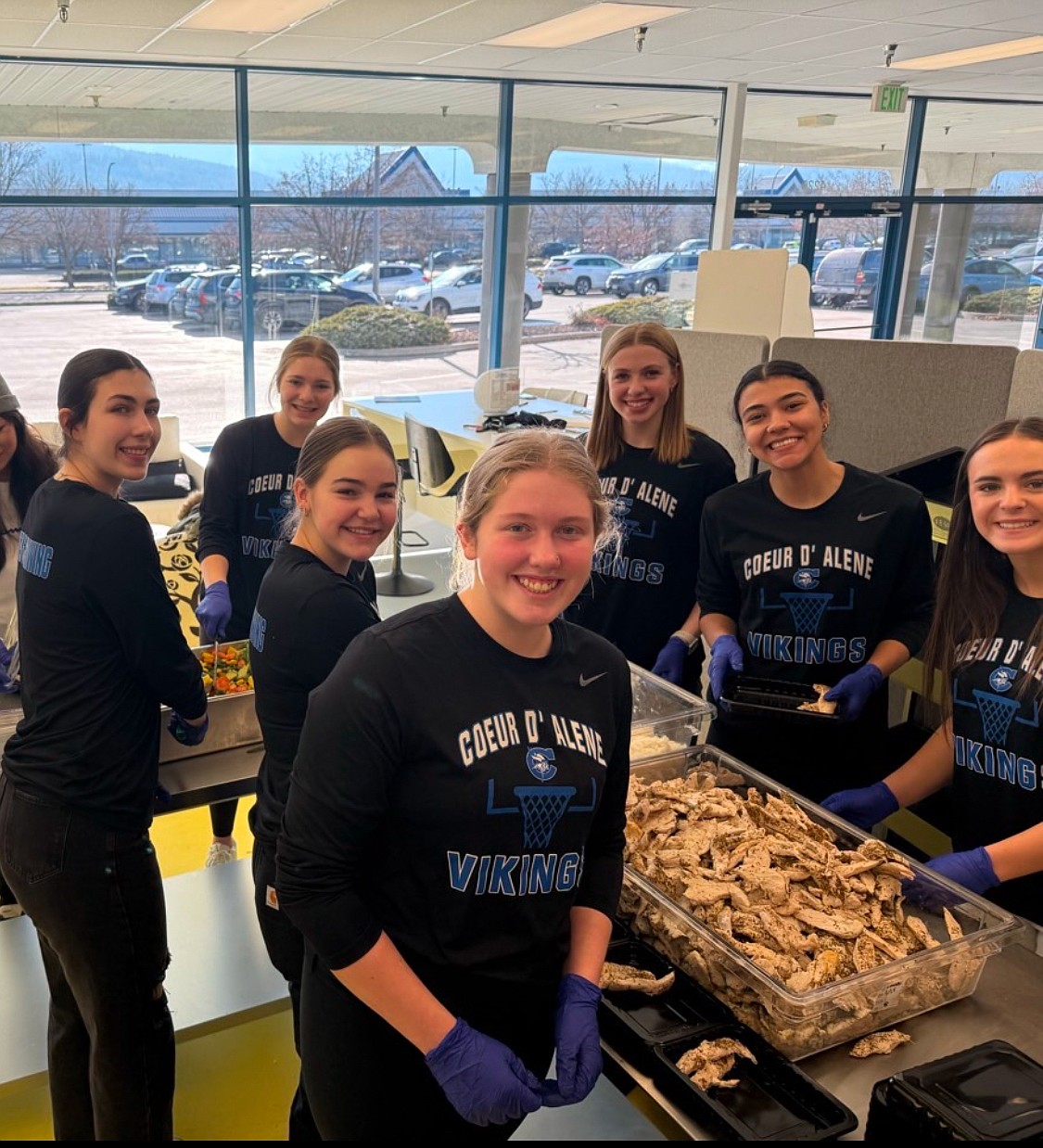 Courtesy photo
Last Friday, members of the Coeur d’Alene High girls basketball program participated in a volunteer initiative in partnership with the Brighter Life Foundation. 
The Brighter Life Foundation’s collaboration with local nonprofit organizations provides free meals to individuals in need within the community. Through the foundation’s partnership with CoPow, every meal purchased results in another meal being donated to someone in need. “This initiative has made a tangible difference in countless lives, and our team was proud to contribute to this cause,” Coeur d’Alene coach Stacy Boyd said. 
The players assisted in the preparation and packaging of pre-made meals for delivery. The event took place at the CoPow Foods Distribution Kitchen in Post Falls. Pictured clockwise from front left are Kelsey Carroll, Lexi Wheeler, Hannah Shafer, Natalie Semprimoznik, Karisa Wallis, Brookeslee Colvin and Kyndal Bridge. Other players who assisted were Bre Reardon and Carlee Bowmer. 
"As the first-year head coach of the CHS girls basketball program, this event epitomized the vision I have for our team,” Boyd said. “By fostering strong bonds off the court, our players have cultivated a level of cohesion and trust that has translated into their success during game competition. I am incredibly proud of the way our players represented Coeur d'Alene High School and the positive impact they’ve made within our community.”