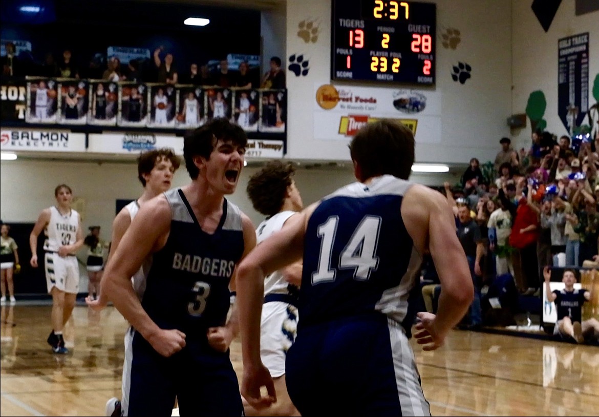 Eli Blackmore (left) is fired up after Thomas Bateman's (right) first in-game dunk of the season.