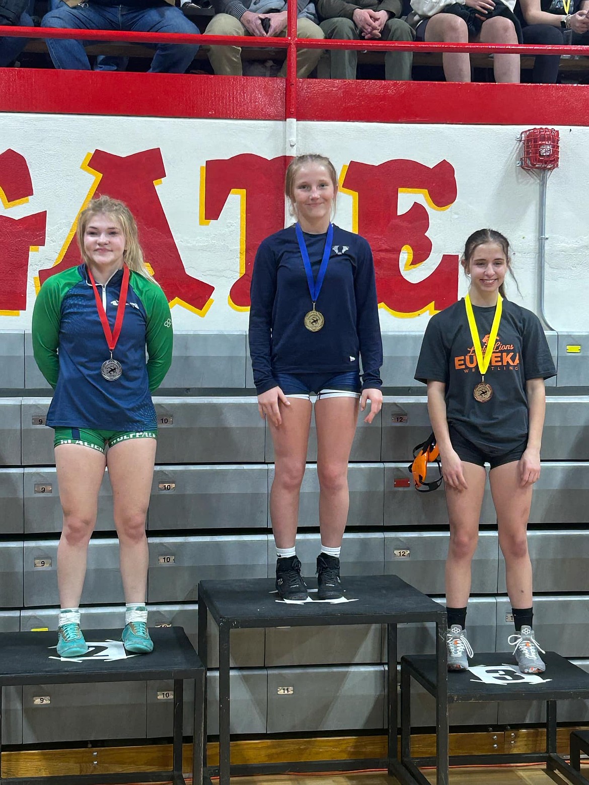 Bonners Ferry's Neveah Therrien (middle) stands atop the podium after winning the 110-pound bracket of the Hellgate Girls Wrestling Invitational held this Friday and Saturday in Missoula.