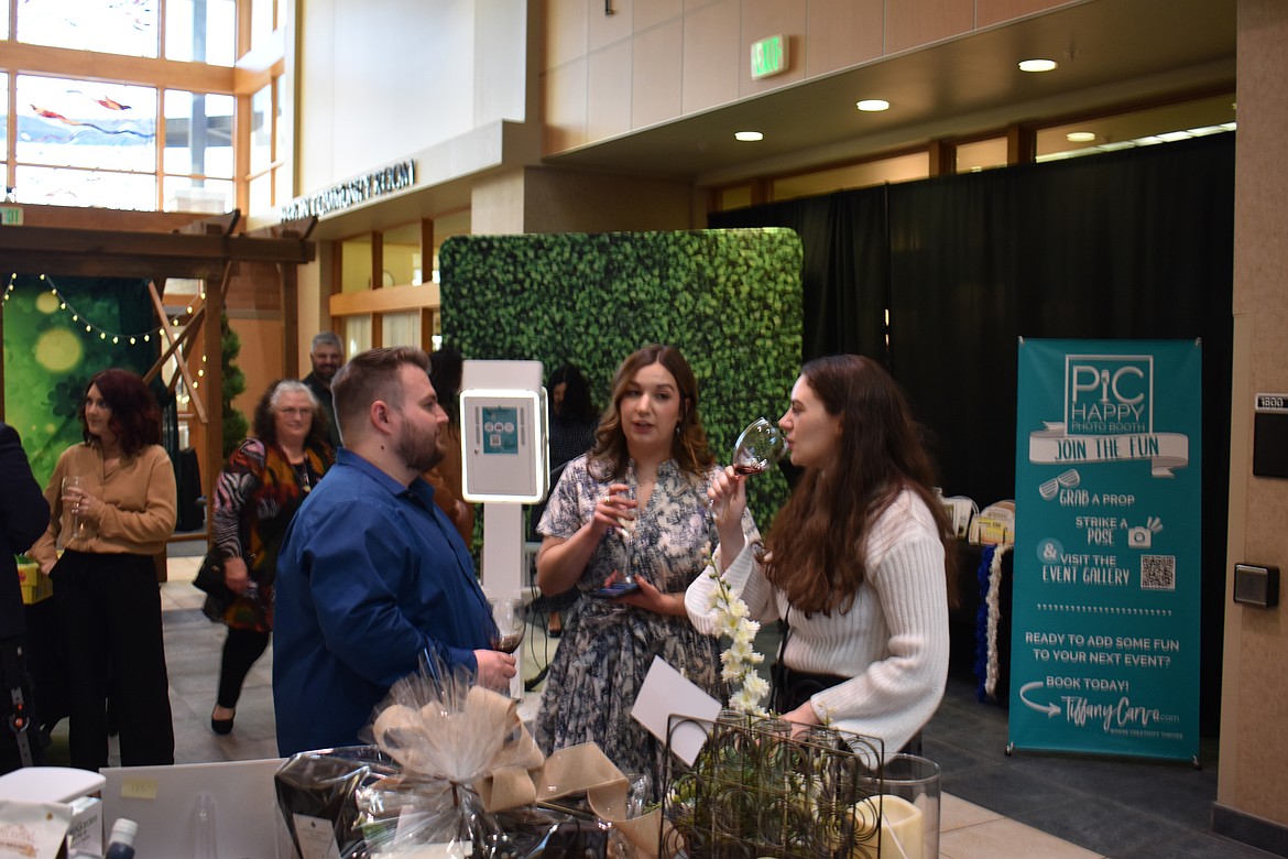 From left: Tanner Warkentin, Jalen Garza and Caitlin Boss catch up over a glass of wine at the 2024 Cellarbration!