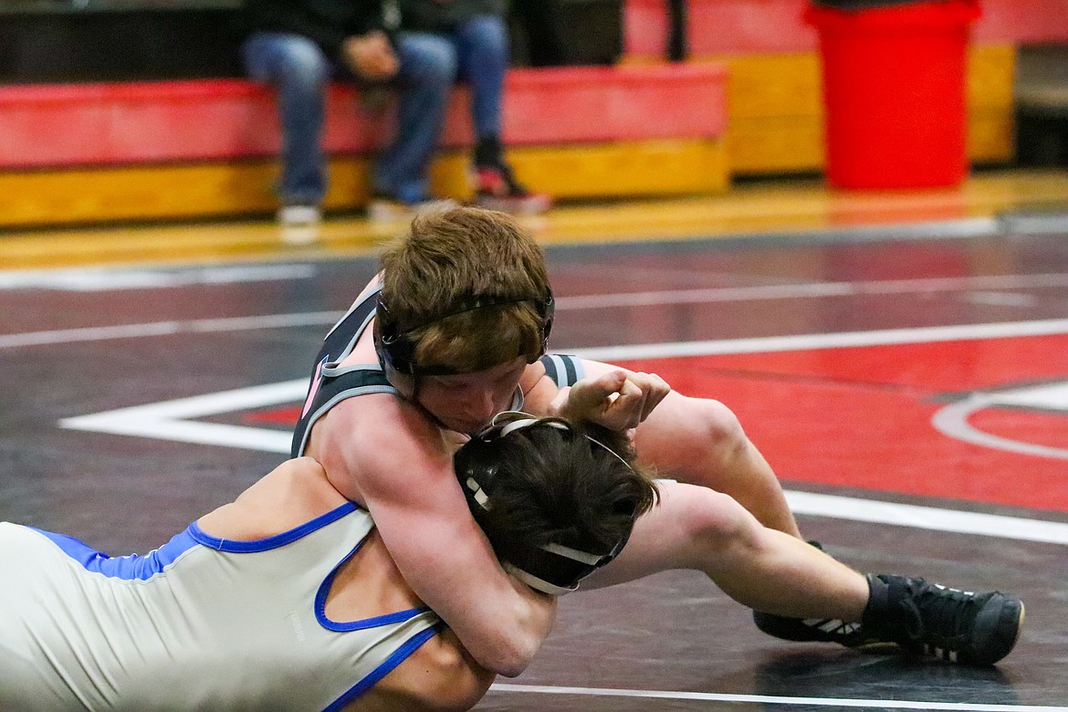 Othello junior Dallin Hammond, top, works to flip his opponent onto his back.