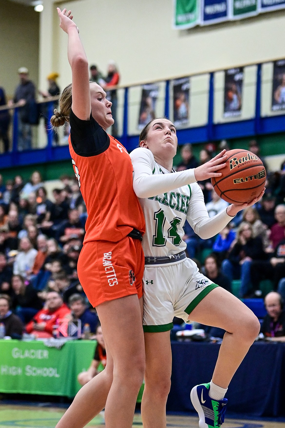 Glacier's Karley Allen (14) goes to the basket defended by Flathead's Grace Gall (23) in the second half at Glacier High School on Friday, Jan. 24. (Casey Kreider/Daily Inter Lake)