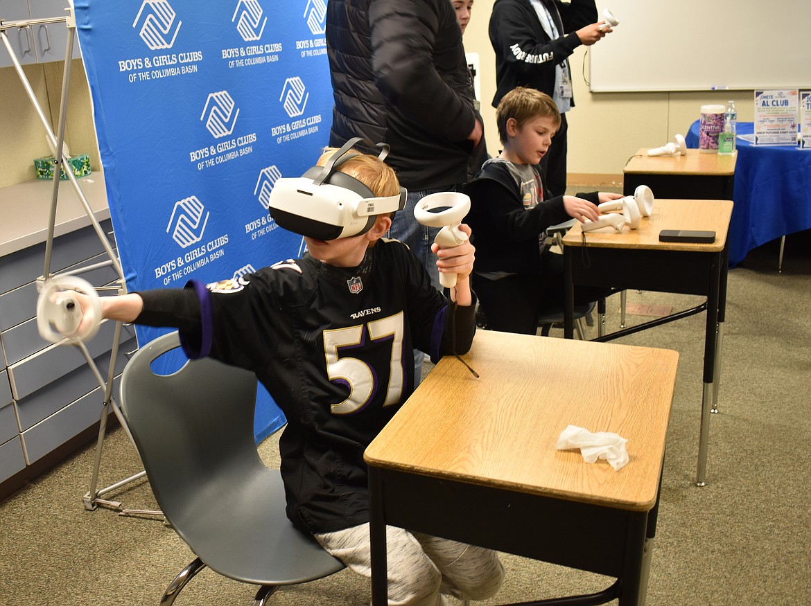Sabastian Evans, 10, performs a virtual knee surgery at the NCW Tech Alliance STEM event Thursday in Moses Lake. An estimated 600 people turned out for the first of three events designed to get students excited about science and technology.