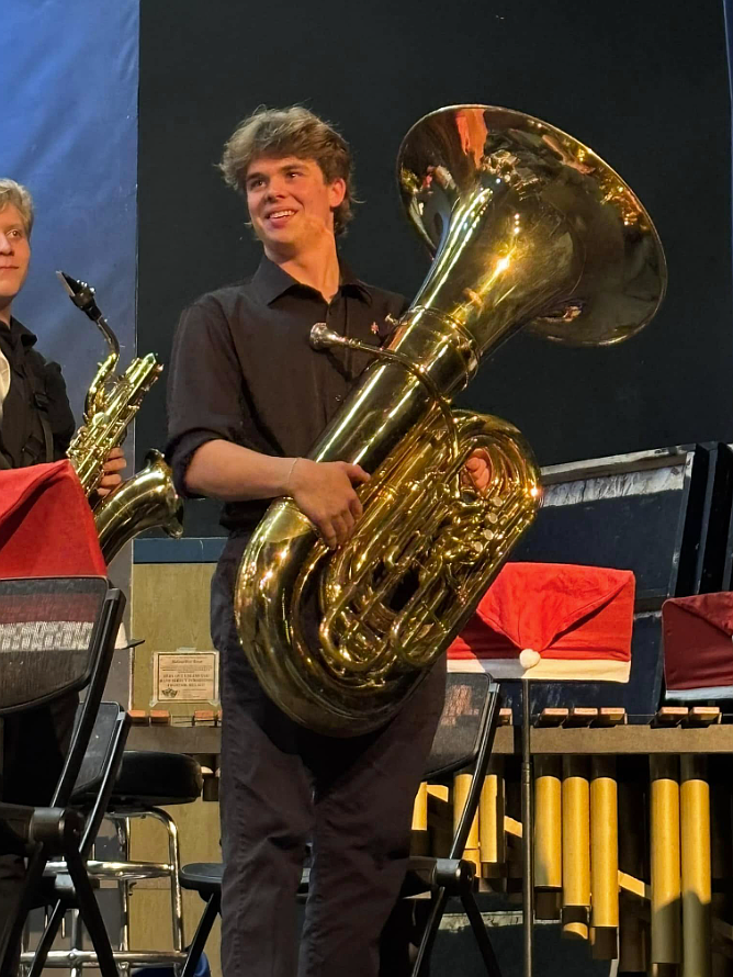 Coeur d'Alene High junior Sheen Broncheau is pictured with John Tindall's tuba during a recent performance. Sheen spoke Jan. 14 to the Coeur d'Alene High Booster Club about the importance of having instruments in good condition for student use. Many of the school's student instruments are at least 70 years old.