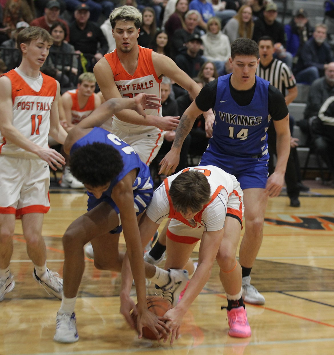 JASON ELLIOTT/Press
Maxwell Riley of Coeur d'Alene and Connor Carver of Post Falls reach for a loose ball during the first quarter of Saturday's Inland Empire League game at The Arena.