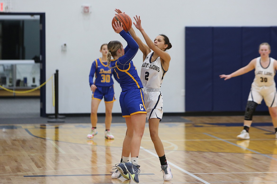 MLCA/CCS junior SanTahna Ferguson (2) defends against a Wilson Creek player during the first half of Thursday’s game. Ferguson tied for a team-high eight points Thursday night against the Devils.