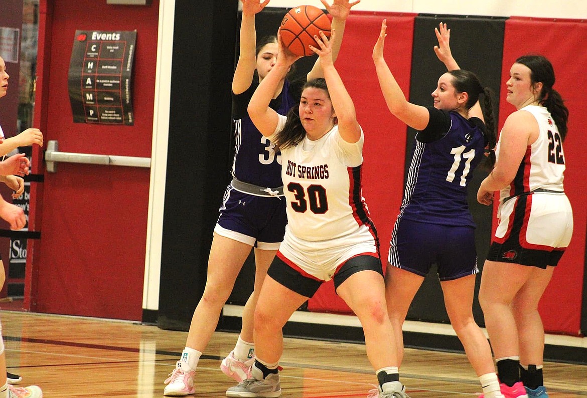 Hot Springs forward Erica Cannon looks to pass while being defended by several Charlo players during their game Saturday night in Hot Springs. (Photo by Ginger Zempel)