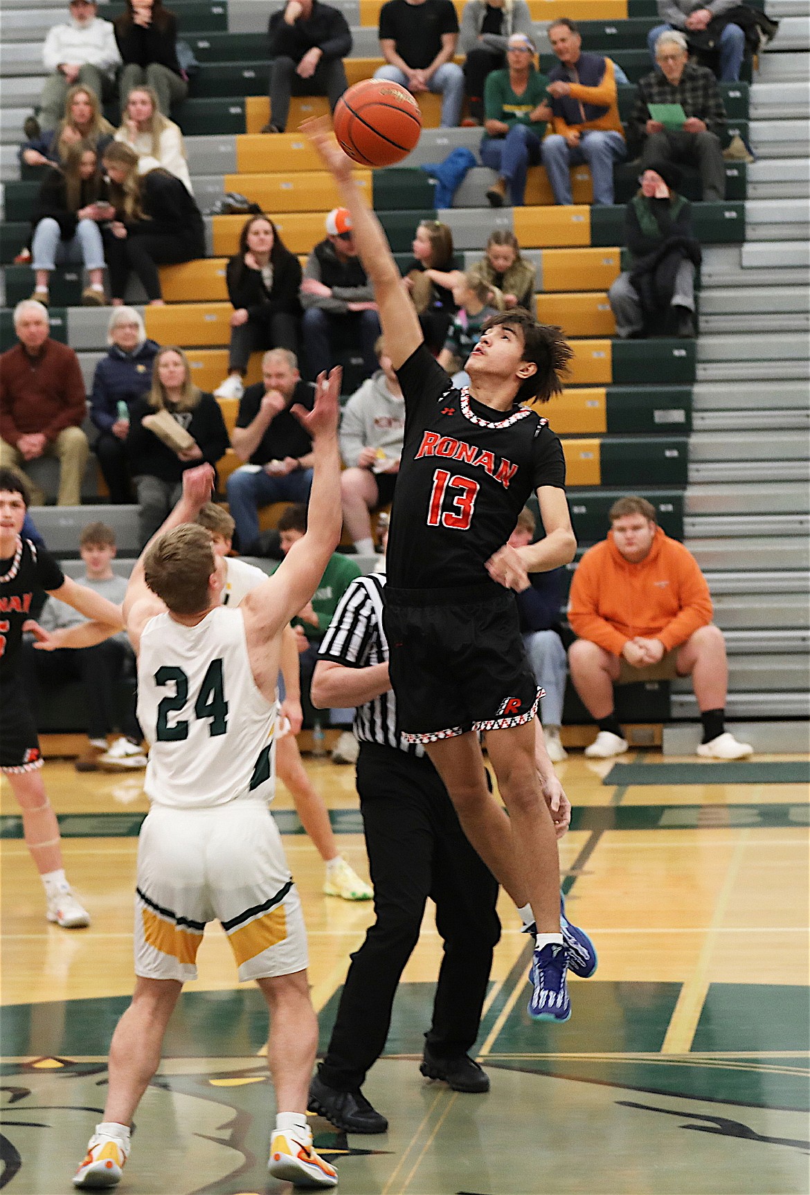 Chief Sean Small tips the ball to set the tone for Ronan's win over the Whitefish Bulldogs. (Susan Lake photo)