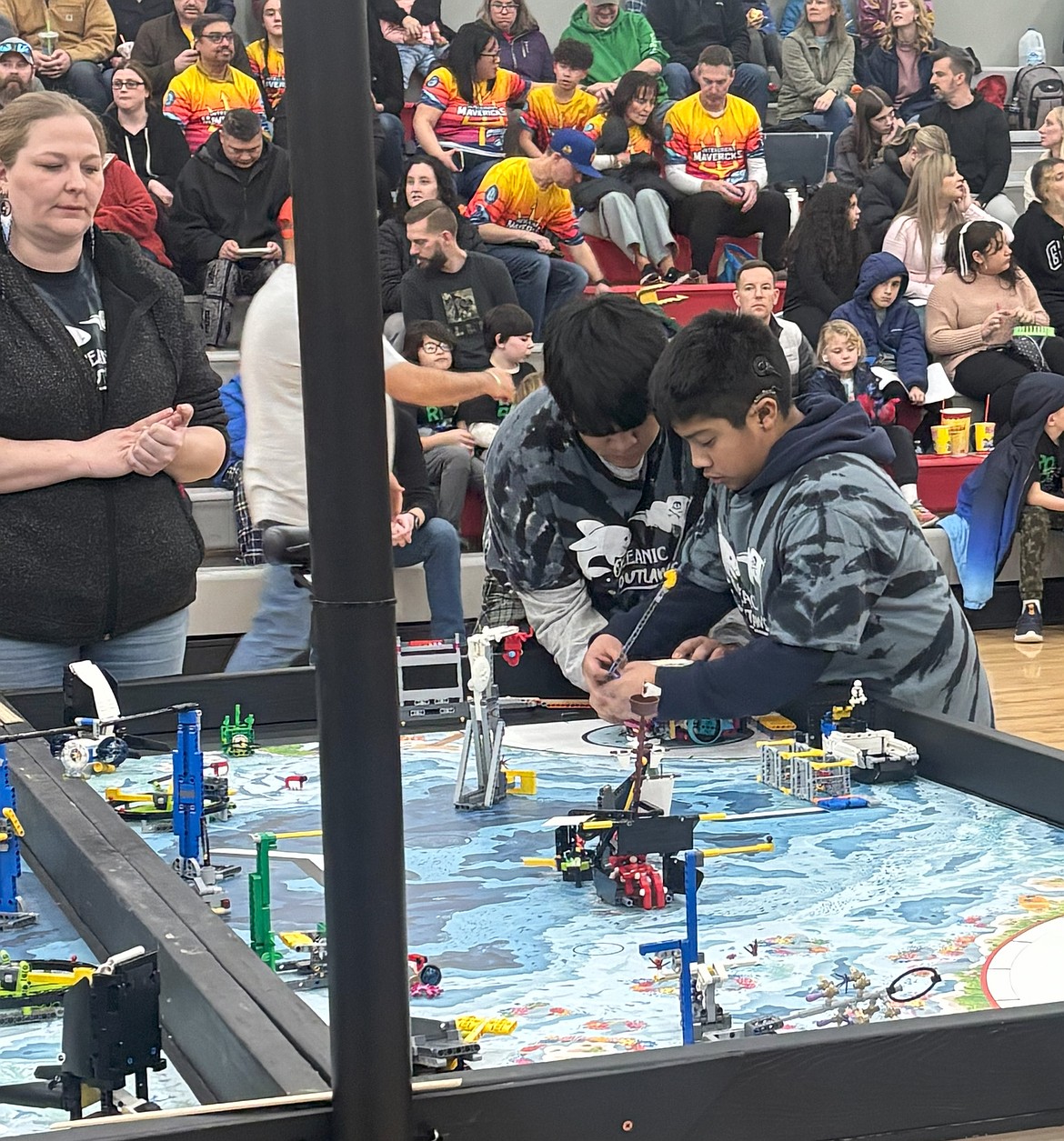 Members of the Royal Middle School Oceanic Outlaws robotics team set up the robot game challenge at the state competition in Spokane Jan. 18.