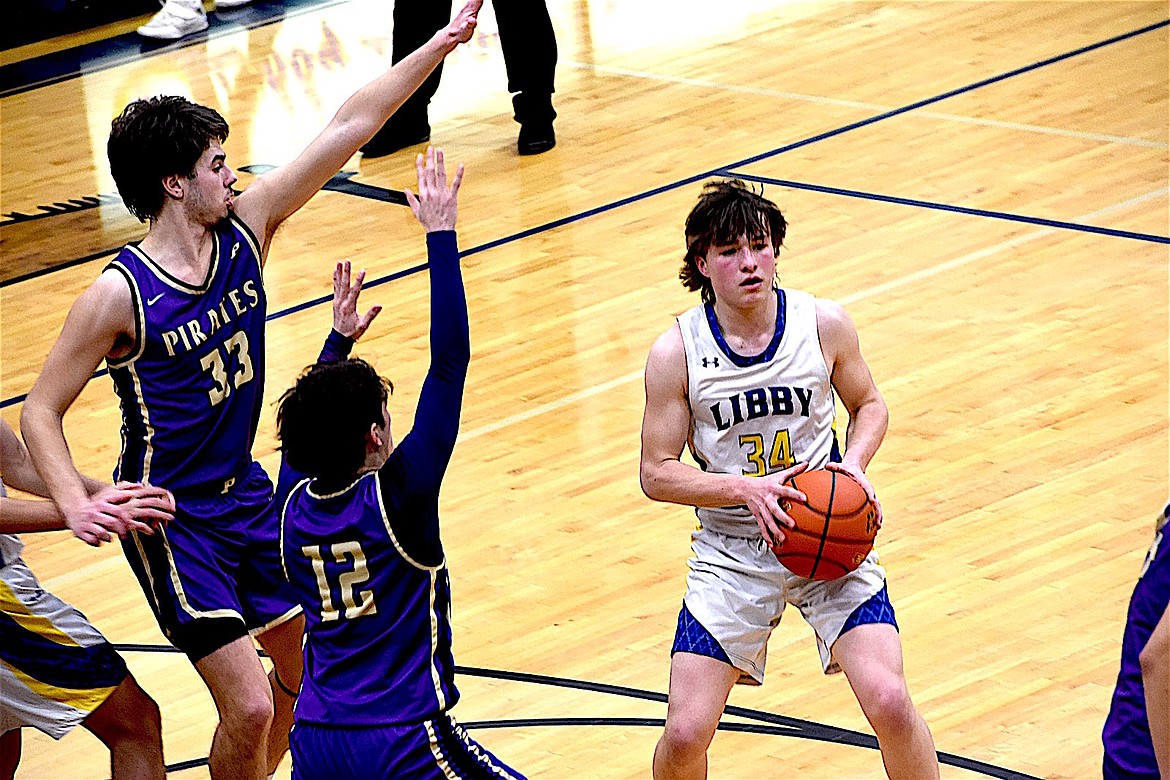 Libby's Bransen Holzer looks to pass against Polson during a Jan. 25, 2025, game. (Scott Shindledecker/The Western News)