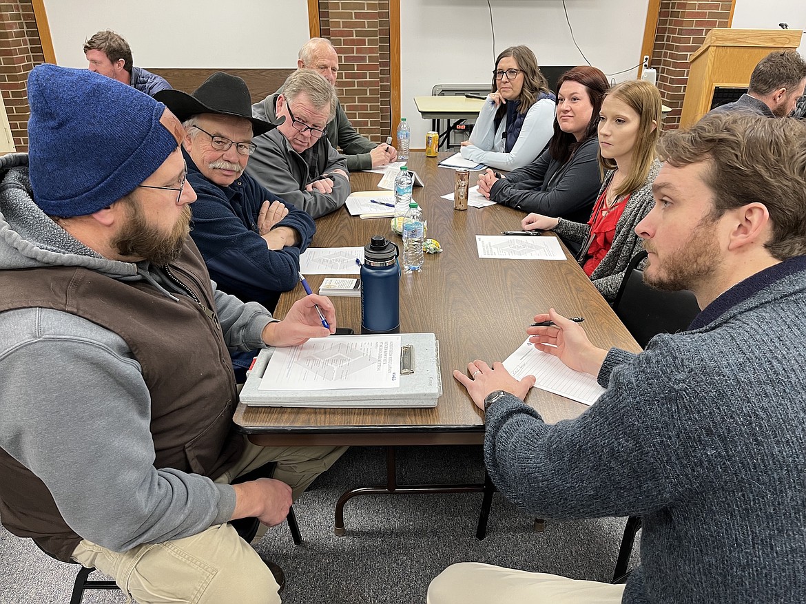 Jess Kittle (left) discusses housing issues with Joe Dehnert (right) of IMEG Consulting and other participants in last Friday's public meeting at the Lake County Courthouse. (Kristi Niemeyer/Leader)