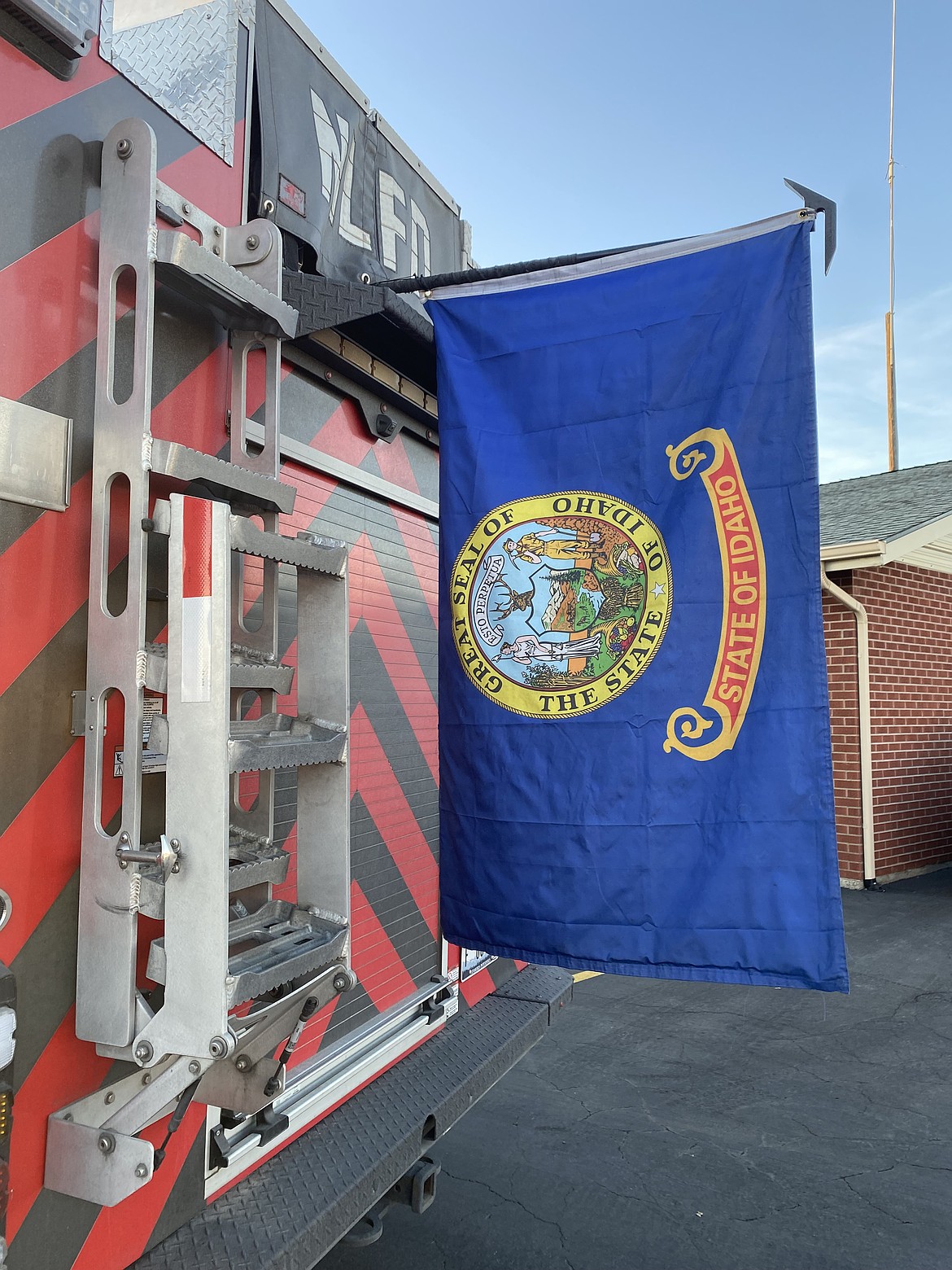 The state flag of Idaho hangs from the back of a Northern Lakes Fire Protection District vehicle. The Northern Lakes crew of four returned from assisting during the Los Angeles County fires Tuesday afternoon.