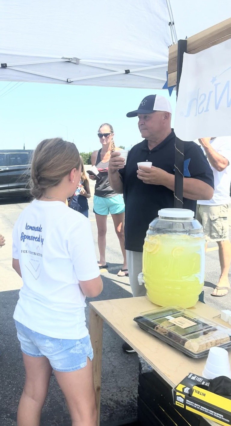 McKenzie McMurray serves up lemonade at her stand during a hot day in summer 2024. The 10-year-old entrepreneur is a winner in the Holiday Lemonade Day Pitch Contest and will be serving prickly pear lemonade at her stand this summer.