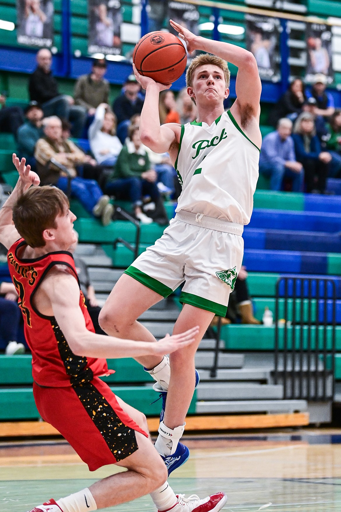 Glacier's Liam Ells (2) draws a blocking foul en route to the hoop in the first quarter against Missoula Hellgate at Glacier High School on Thursday, Jan. 30. (Casey Kreider/Daily Inter Lake)