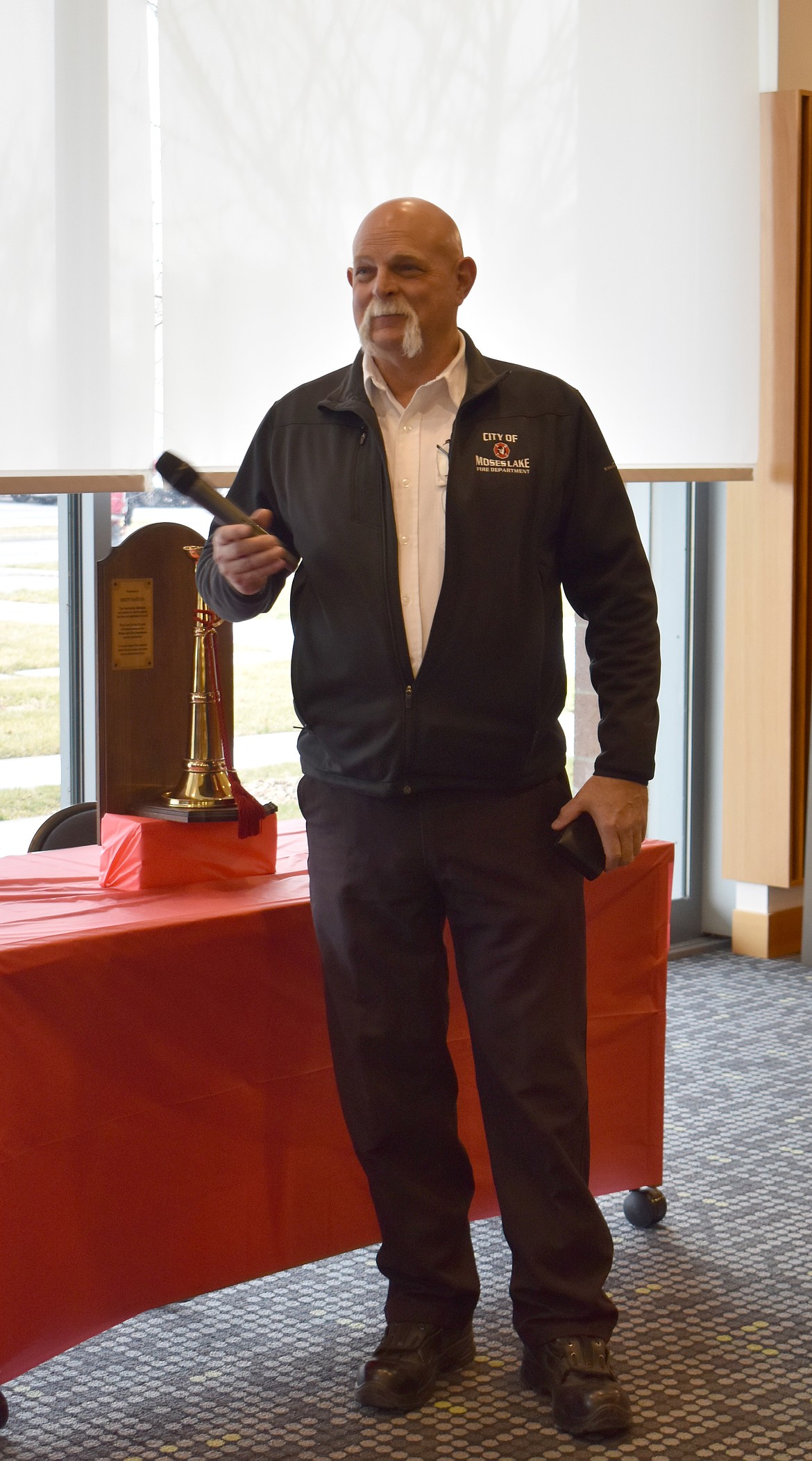 Moses Lake Fire Chief Brett Bastian addresses a roomful of fellow first responders and city staff at his retirement party Friday.