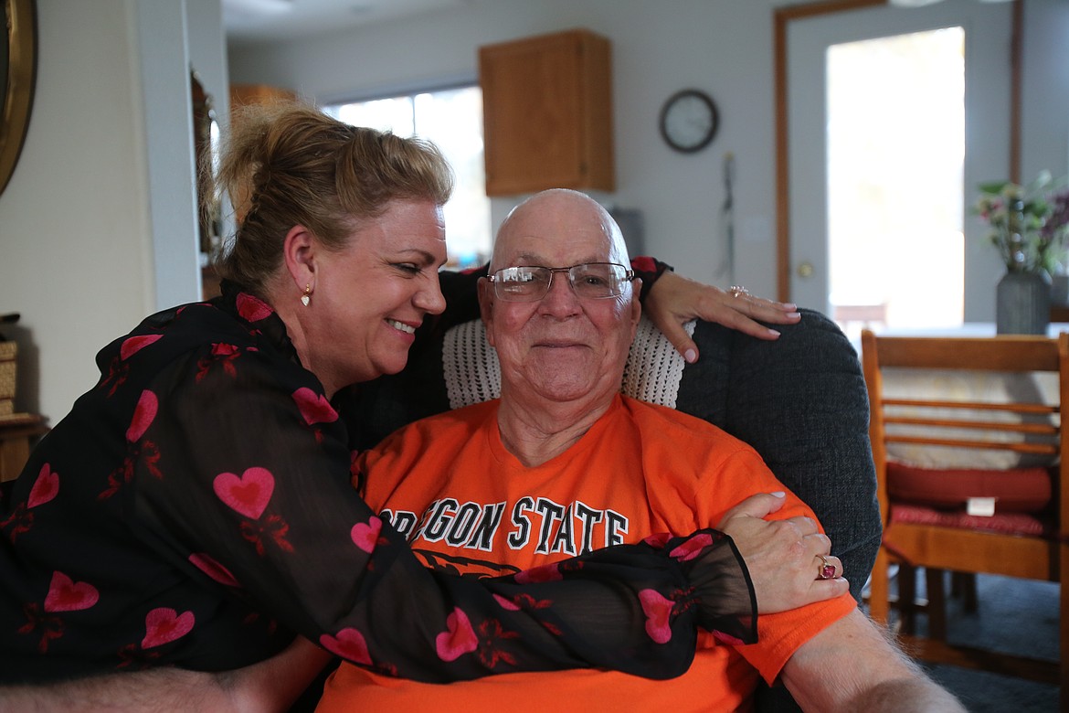Vesta Hager throws her arms around her dad, Richard Gauntlett, Jan. 20 as he discusses all the ways that life got in the way before he could go back to school. More than six decades after having to leave college because of illness, Gauntlett is proud to be an online student at Oregon State University.