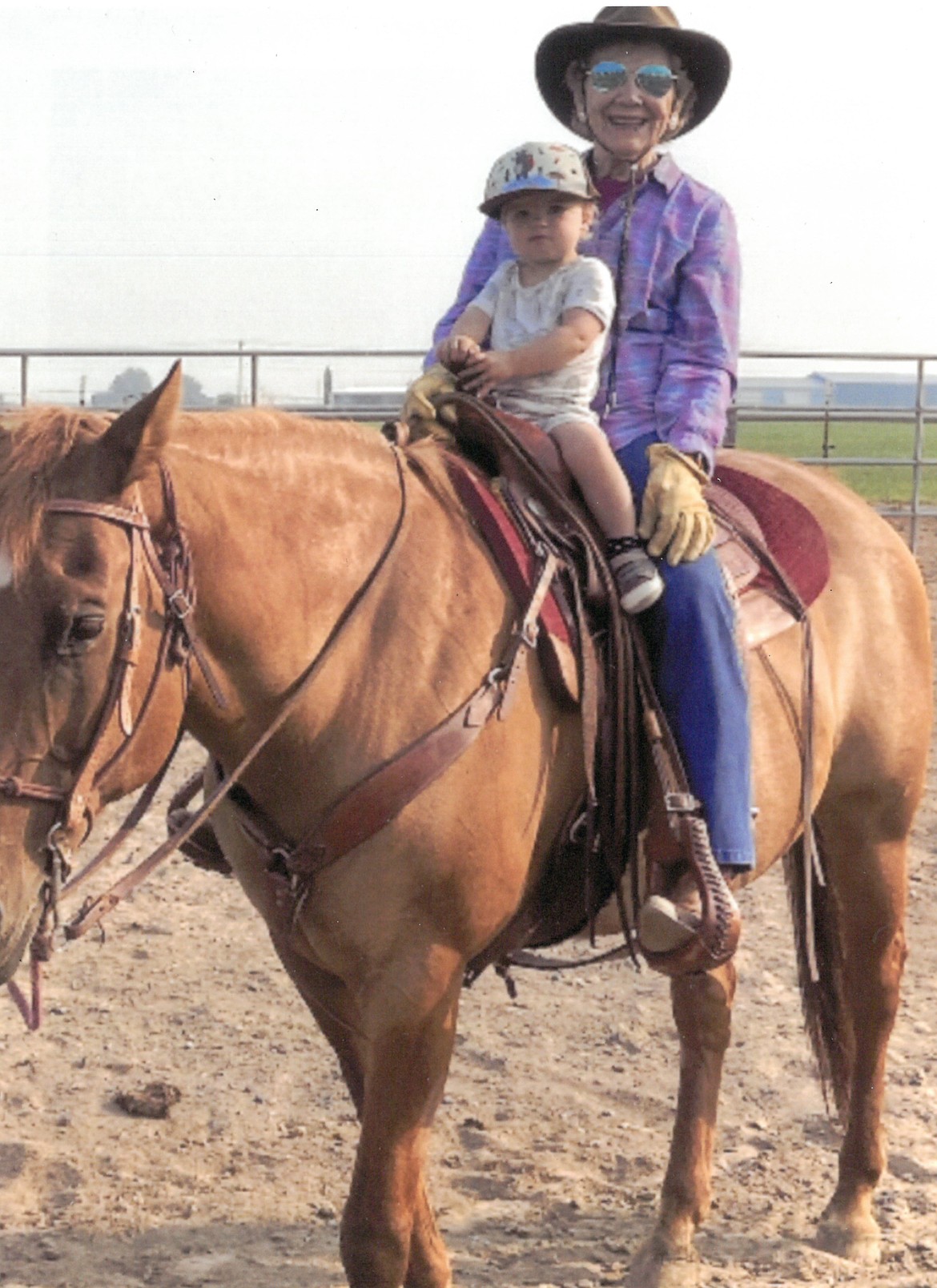 Betty Warnick introduces a grandchild to horsemanship. She kept riding into her 90s, she said.