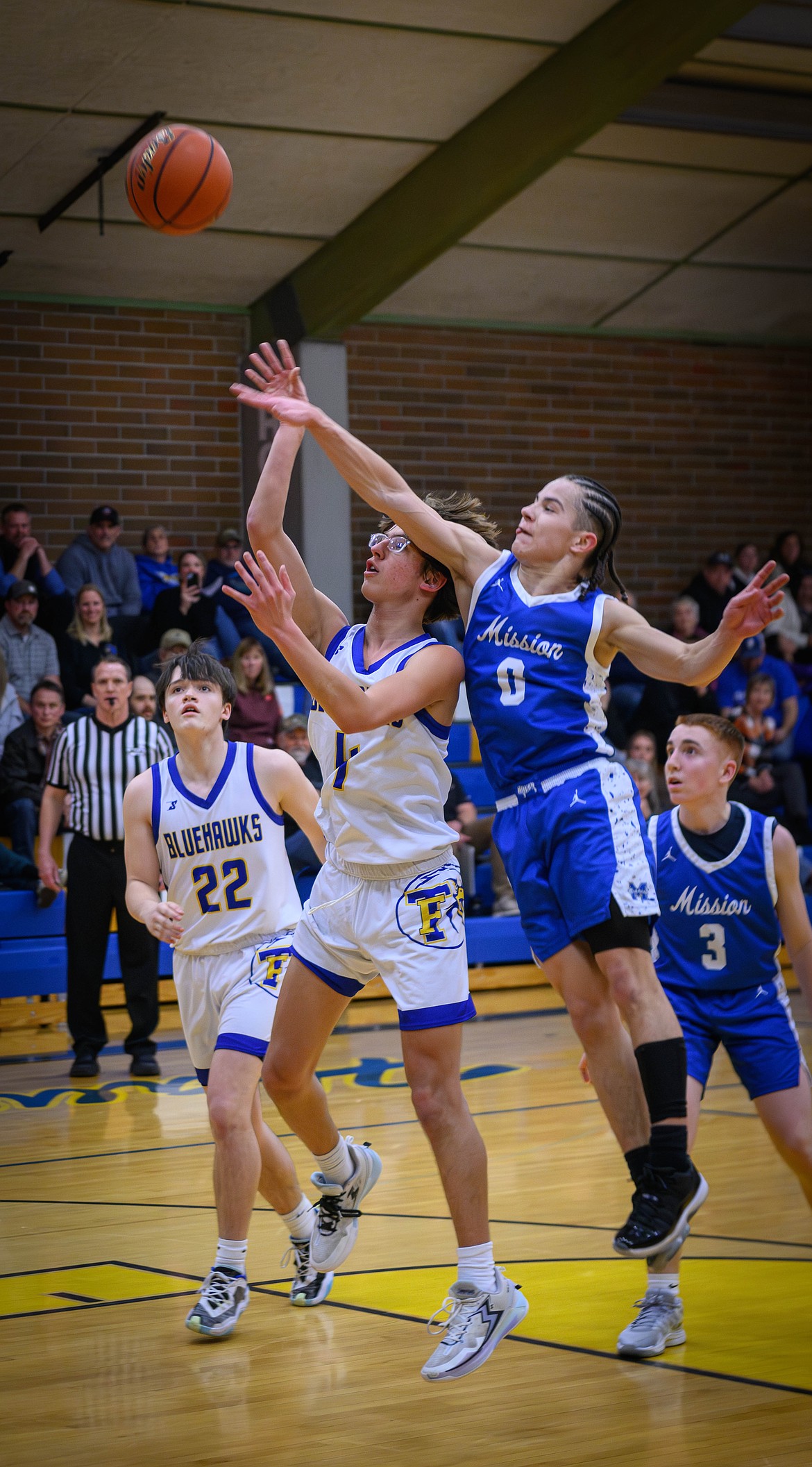 Thompson Falls' Owen Doyle (white) gets a shot past St. Ignatius guard Lex LaFrombois during their Western 7B conference game this past week in T Falls.  (Tracy Scott, Valley Press)